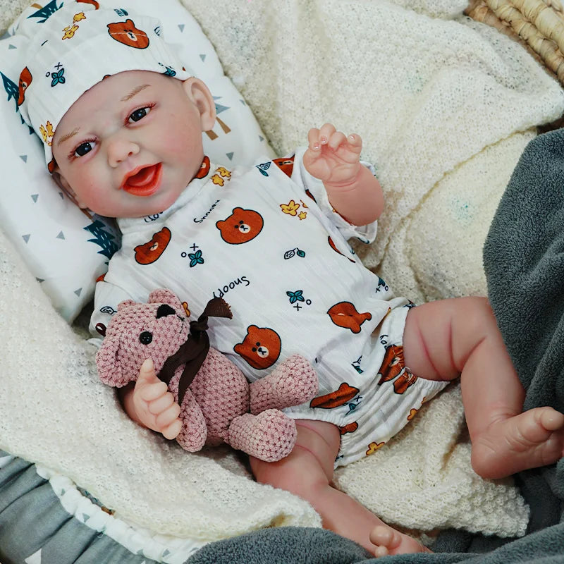 The reborn baby doll smiling brightly, dressed in a white animal print outfit, cuddling with a soft teddy bear.