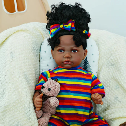 The fourth image features the baby doll sitting up, with both hands holding the teddy bear, wearing the rainbow-striped headband.
