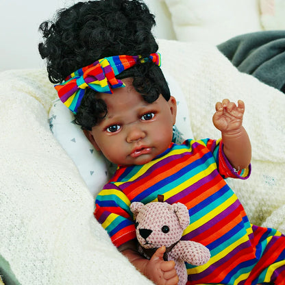 The final image shows the baby doll lying on a white blanket, holding the teddy bear, depicting a resting position.