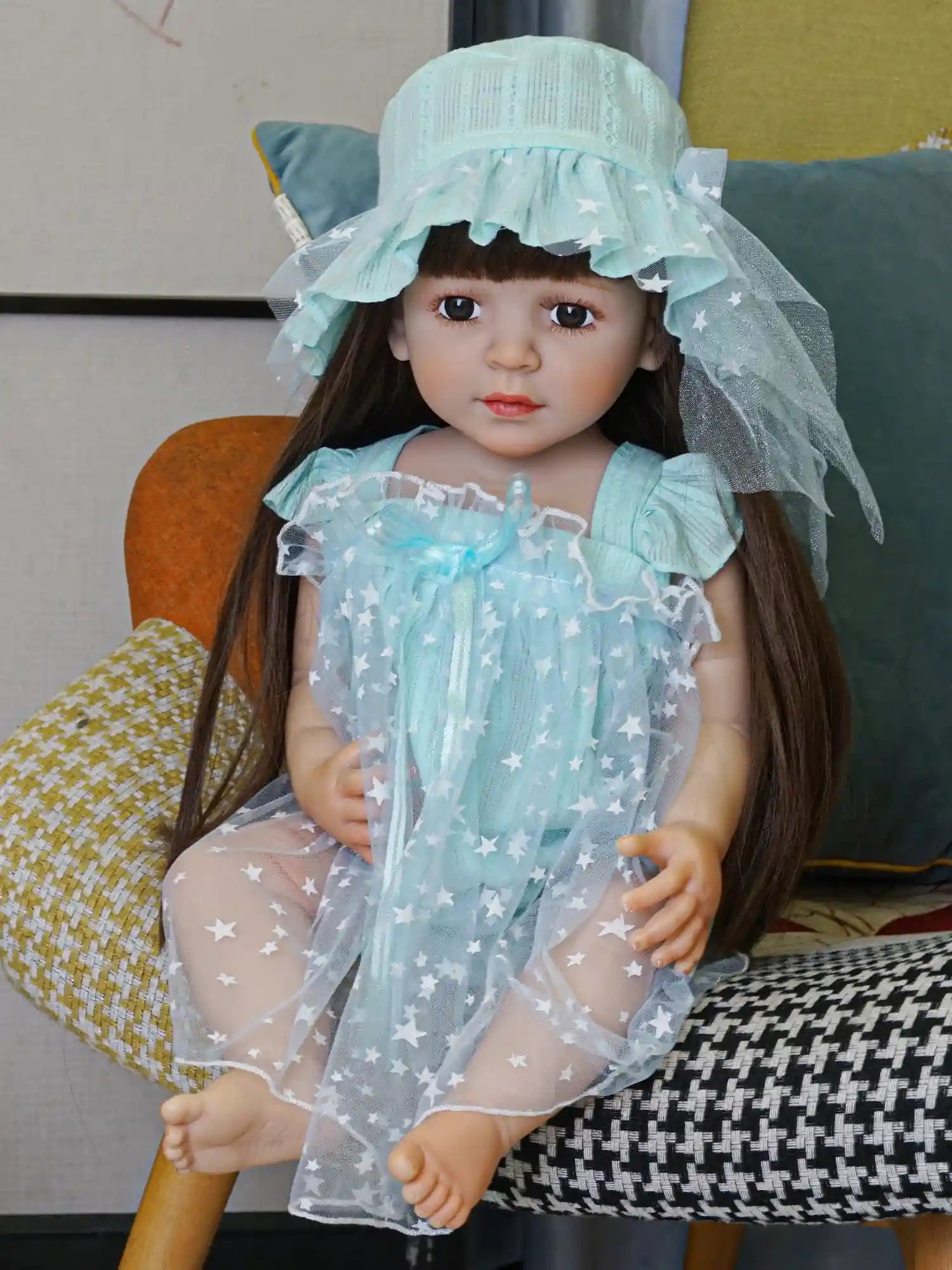 Charming doll with expressive eyes, dressed in a light blue dress with star details.