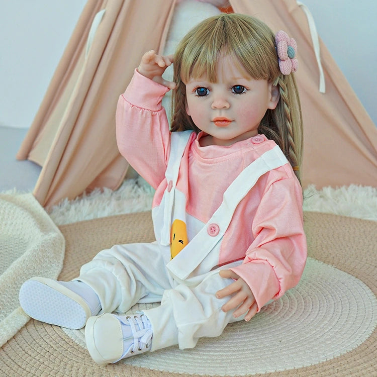 reborn toddler doll, in a cute pink suspender set