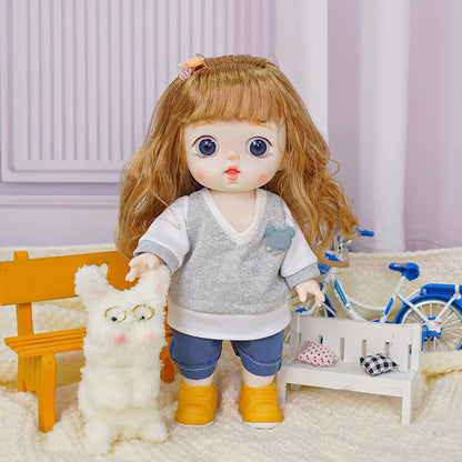 A doll with brown wavy hair and blue eyes, dressed in a gray sweater and blue jeans, stands next to a fluffy white toy dog with glasses.