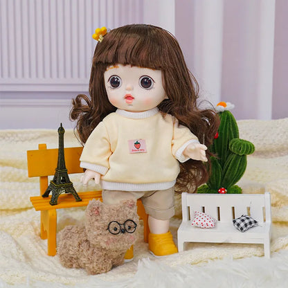 A doll with expressive brown eyes and lush hair, wearing a cream sweater and beige pants, poses with a cactus.