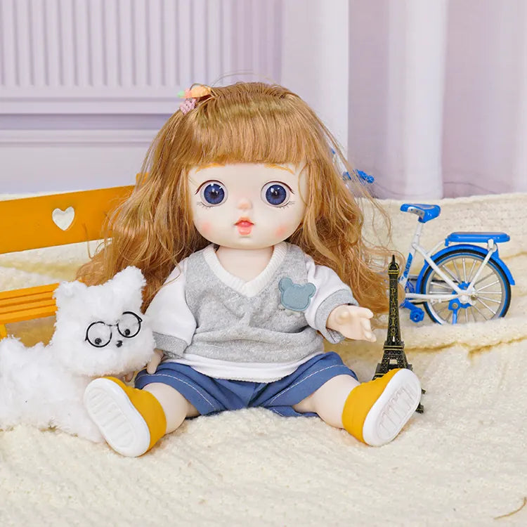 A toy doll with expressive features paired with a white fluffy dog wearing round spectacles, in a playroom setting.