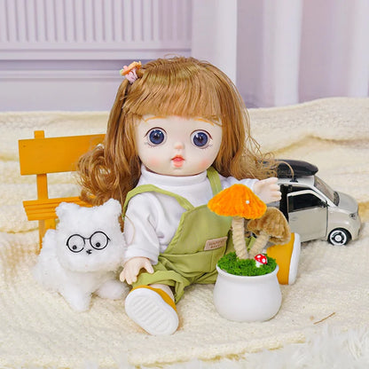 A friendly-faced doll with overalls and toy accessories, including a fluffy white cat and miniature vehicle.