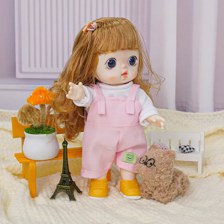 A doll with animated facial features dressed in playful overalls stands near a unique fuzzy toy and a scale model of the Eiffel Tower.